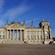 The Reichstag, a stately stone building with a columned entrance and German flags
